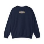 Navy sweatshirt shown from the back with a small tan label on the upper center that reads 'Designed By The Simple Design Mindset'