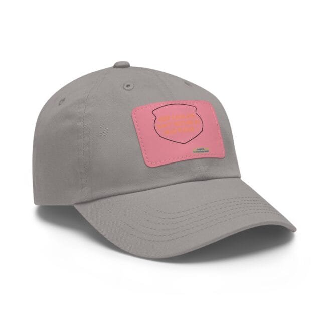 Gray baseball cap with a pink patch on the front panel, viewed from the side-left.