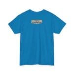 Back view of a bright blue T-shirt with a small beige label centered near the neck that reads Designed By The Simple Design MindSet.