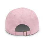 Close-up of a pink baseball cap viewed from above, showing crown panels and a brass buckle strap.