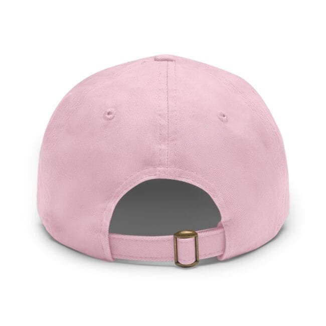 Close-up of a pink baseball cap viewed from above, showing crown panels and a brass buckle strap.