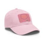 Close-up of a soft pink baseball cap with visible stitching and a front pink patch