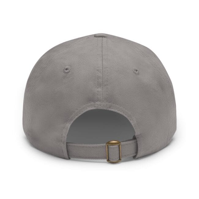 Close-up of a gray baseball cap showing the crown, panels, and an adjustable back strap with a brass buckle from a top-front angle