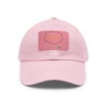 Close-up of a pink baseball cap facing upward, showing a stitched front patch on the cap's surface.