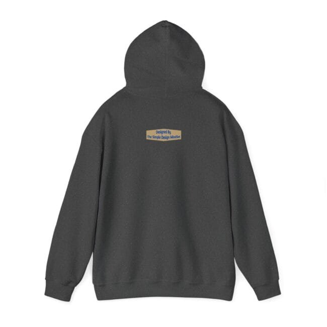 Back view of a dark gray hoodie with a small beige brand patch centered on the upper back that reads 'Designed By The Simple Design Mindset'