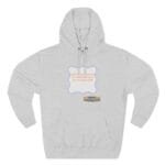 Grey hoodie with a decorative blue-bordered label on the chest, containing orange text about continuous learning and culture. A small tan label at the lower right reads 'Designed By The Simple Design Mind' (brand credit).