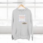 Gray hoodie on a hanger with a blue-framed orange text slogan: 'Continuous learning is improving your culture's mindset.' with a small designer label.