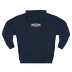 Navy hoodie viewed from the back with a small tan label centered near the neck reading 'Designed By The Simple Design MindSet'.