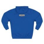Back view of a royal blue hoodie with a small tan label on the upper back reading, "Designed By The Simple Design MindSet."
