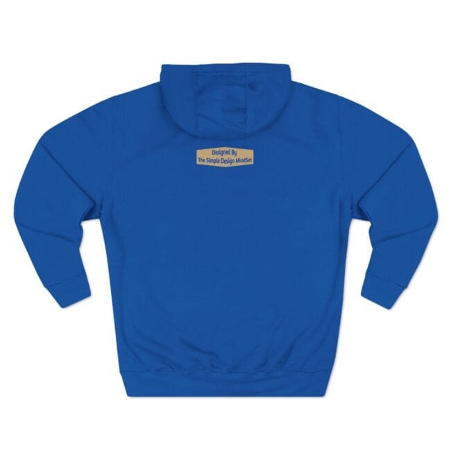 Back view of a royal blue hoodie with a small tan label on the upper back reading, "Designed By The Simple Design MindSet."