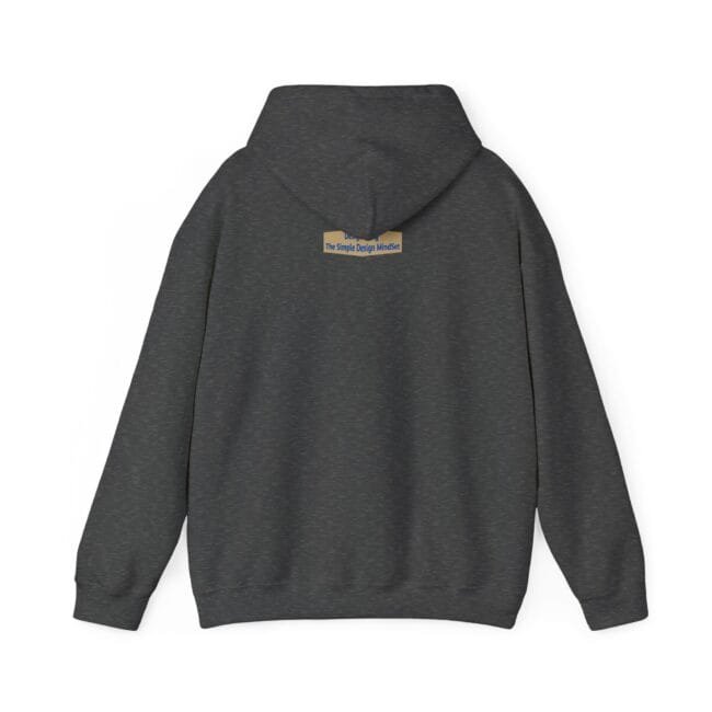 Dark heather gray hoodie viewed from the back with a small beige label on the upper back reading 'The Simple Design Mindset'
