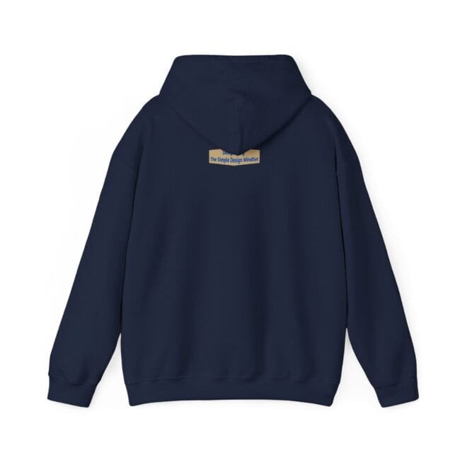 Navy hoodie shown from the back with a small beige label on the upper back reading, “The Simple Design Mindset.”