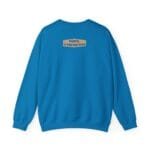 Back view of a blue sweatshirt with a small beige label on the upper back that reads 'Designed By The Simple Design MindSet'
