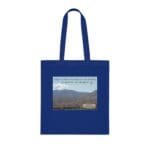Blue tote bag featuring a desert landscape print and the quote about coffee or juice in the desert to resolve the problem.