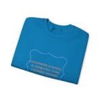 Blue folded T-shirt with an orange quote inside a decorative purple frame: 'Continuous learning is improving your cultures' mindset'