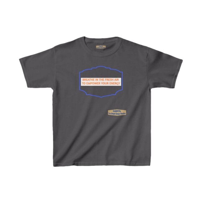 Grey t-shirt featuring a blue ornamental frame with the orange slogan: 'BREATHE IN THE FRESH AIR TO EMPOWER YOUR ENERGY' center-front, plus a small beige label reading 'Designed By The Simple Design MindSet'