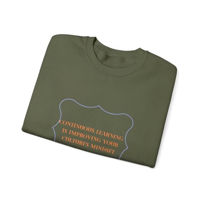 Folded olive-green sweatshirt with orange slogan reading "CONTINUOUS LEARNING IS IMPROVING YOUR CULTURE'S MINDSET" inside a blue decorative border.
