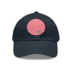 Navy baseball cap with a pink circular patch on the front.
