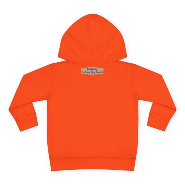 Back view of a bright orange hoodie with the hood up and a small beige label at the neckline reading 'Designed By The Simple Design MindSet'.