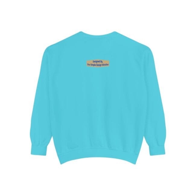 Back view of a turquoise sweatshirt with a small beige label that reads 'Designed By The Simple Design Mindset' at the upper back center.