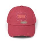 Pink distressed baseball cap with an orange quote on the front: 'Continuous learning is improving your culture’s mindset' and a beige designer label below reading 'Designed By The Simple Design MindSet'.