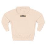 Back view of a light peach hoodie with a small yellow brand patch at the upper back reading 'Designed By The Simple Design MindSet'.
