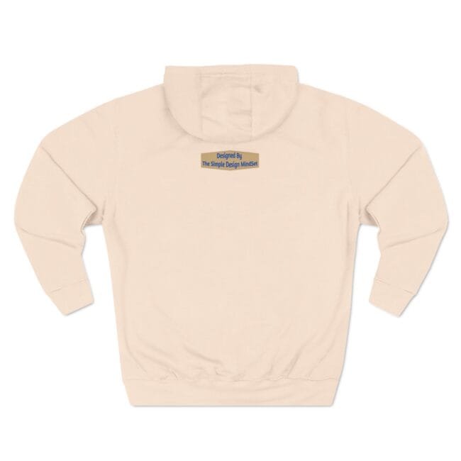 Back view of a light peach hoodie with a small yellow brand patch at the upper back reading 'Designed By The Simple Design MindSet'.
