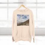 Beige hoodie with a square landscape print on the chest showing mountains and sky, plus the phrase 'Keep calm and increase your concentration'.