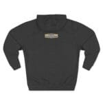 Dark charcoal hoodie with a small tan label on the upper back that reads “Designed By The Simple Design MindSet.”