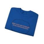 Blue folded T-shirt featuring a black cloud outline with the orange slogan: 'KEEP CALM AND INCREASE YOUR CONCENTRATION'.
