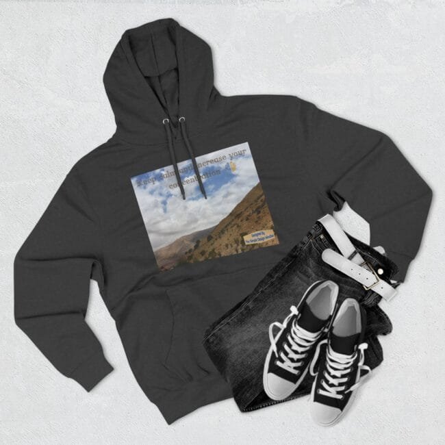 Dark gray hoodie showing a front print of a hillside landscape with blue sky and clouds and the phrase 'Keep calm and increase your concentration'
