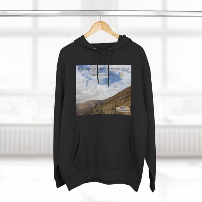 Black hoodie featuring a landscape print on the chest with the phrase 'Keep calm and increase your concentration' and a small designer label.