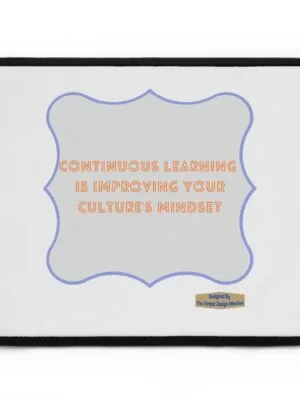 Laptop sleeve with a decorative grey panel featuring an orange quote: “Continuous learning is improving your culture's mindset.” Small design credit appears in the lower right.