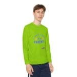 Bright lime-green long-sleeve shirt worn by a person, with text 'TAKE CARE OF MY PARENTS' and small design near the hem