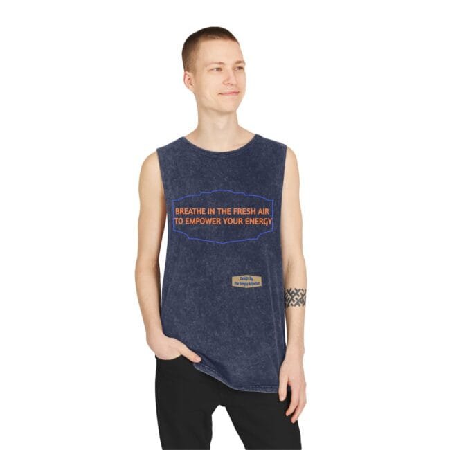 Man modeling a navy acid-wash sleeveless tank top with an orange slogan: 'BREATHE IN THE FRESH AIR TO EMPOWER YOUR ENERGY'.