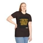 Woman in a dark brown T-shirt with neon-yellow quote reading, 'A princess is a girl or a woman who conserves her ethics' on a black square patch