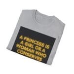 Folded light-gray T-shirt with a black rectangle containing neon-yellow text: 'A PRINCESS IS A GIRL OR A WOMAN WHO CONSERVES'
