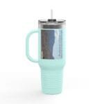 Mint-colored insulated tumbler with straw and a landscape-label on the side showing a desert scene.