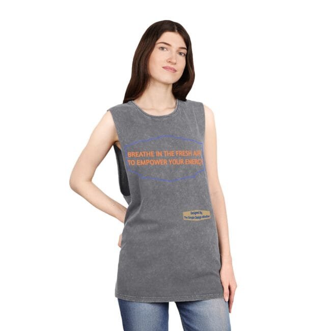 Woman wearing a sleeveless grey T-shirt with an orange slogan that reads, 'BREATHE IN THE FRESH AIR TO EMPOWER YOUR ENERGY,' standing against a white background.