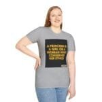 Woman wearing a gray t-shirt with a black square graphic displaying the neon yellow text: 'A PRINCESS IS A GIRL OR A WOMAN WHO CONSERVES HER ETHICS'.