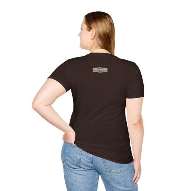 Back view of a person wearing a dark brown t-shirt with a small rectangular label on the upper back, paired with blue jeans.