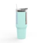 Turquoise stainless steel tumbler with clear lid and straw, featuring vertical labels on the side for a travel mug or coffee cup context.