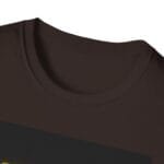 Close-up of a brown crew-neck T-shirt with a dark diagonal stripe across the chest.