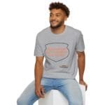 Smiling man wearing a gray t‑shirt with a speech-bubble design that reads: 'KEEP CALM AND DON'T DISTURB MY HEAD PLEASE!'