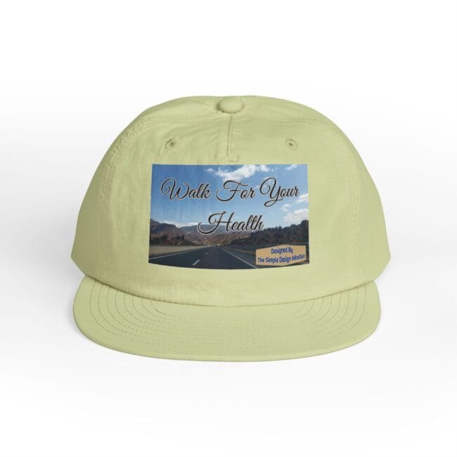 Cap with a patch reading 'Walk For Your Health' over a scenic road image; designer credit visible on the patch's bottom right.