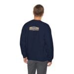 Navy sweatshirt shown from the back with a small tan label on the upper back that reads 'Designed By The Simple Design MindSet'.