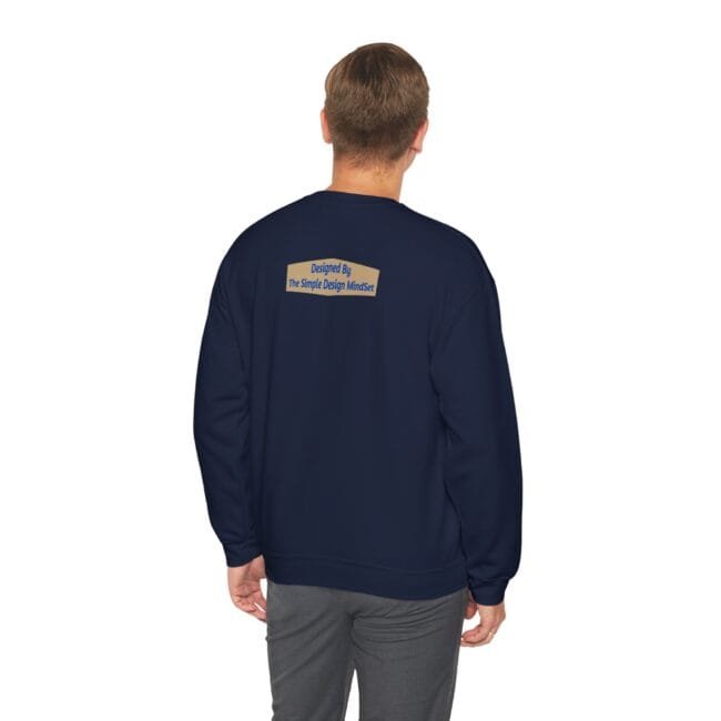 Navy sweatshirt shown from the back with a small tan label on the upper back that reads 'Designed By The Simple Design MindSet'.