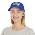 Young woman wearing a royal blue cap with a 'Walk For Your Health' patch on the front, smiling at the camera.