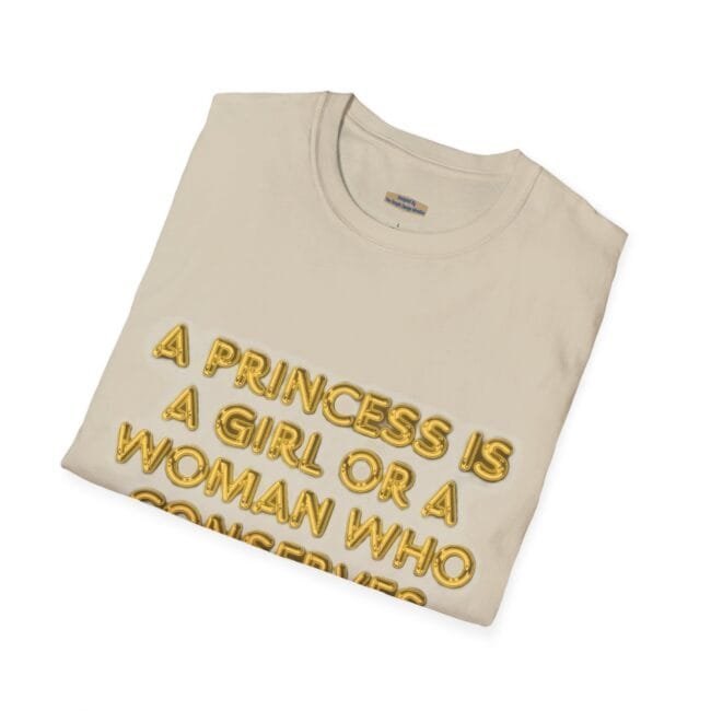 Beige folded T-shirt with gold 3D lettering that reads: “A princess is a girl or a woman who ...”