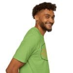 Smiling man with short curly hair and beard wearing a lime green T-shirt, facing to the right in a side profile.